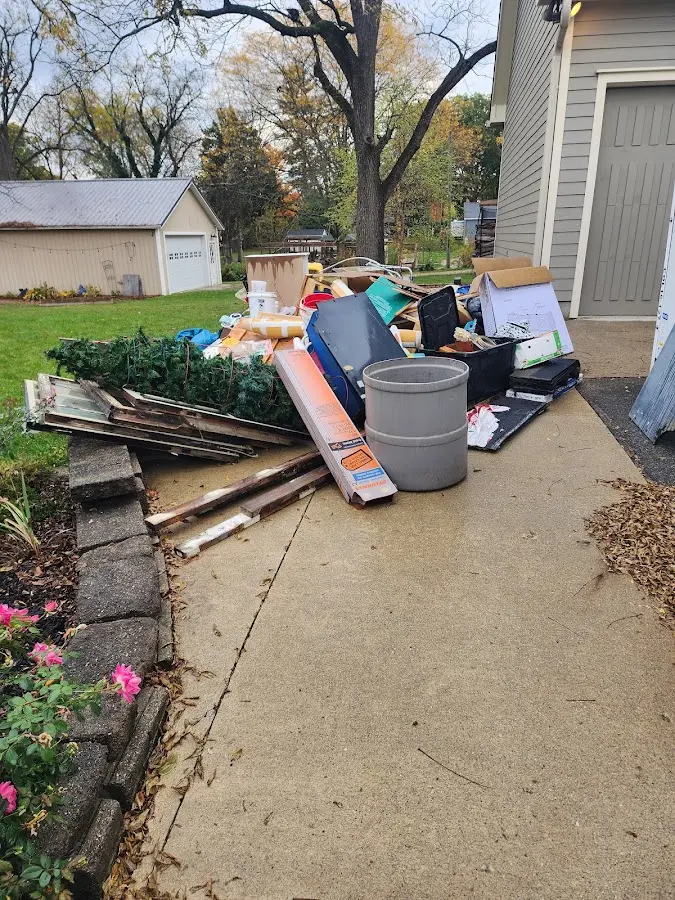 Dumpster being loaded with debris for 10 Yard Dumpster Rental in Douglass